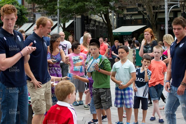 200713 - Cardiff Blues shirt launch - Cardiff Blues launch their new shirt for the 2013-14 season, with a flash mob dance routine outside Cardiff Library