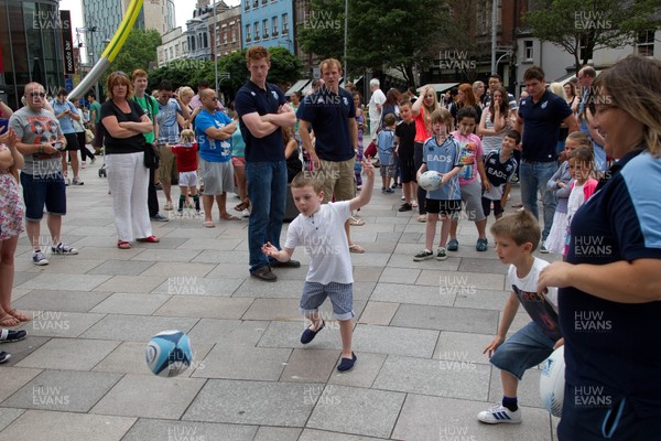 200713 - Cardiff Blues shirt launch - Cardiff Blues launch their new shirt for the 2013-14 season, with a flash mob dance routine outside Cardiff Library