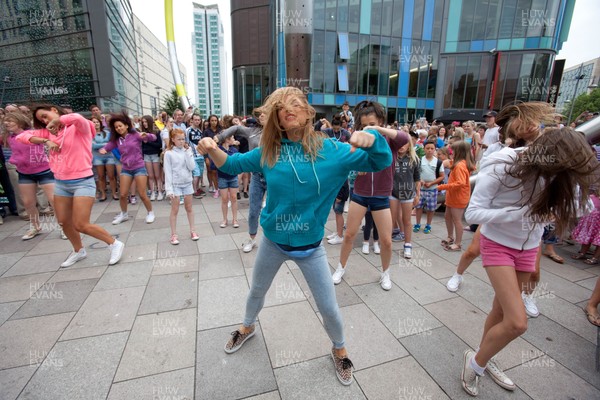 200713 - Cardiff Blues shirt launch - Cardiff Blues launch their new shirt for the 2013-14 season, with a flash mob dance routine outside Cardiff Library