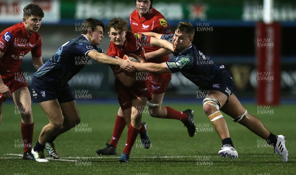 230118 - Cardiff Blues U18s v Scarlets U18s - Llew Smith of Scarlets is tackled by Max Lucas and Dylan Rigby of Cardiff