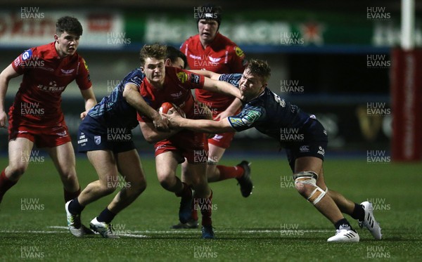 230118 - Cardiff Blues U18s v Scarlets U18s - Llew Smith of Scarlets is tackled by Max Lucas and Dylan Rigby of Cardiff