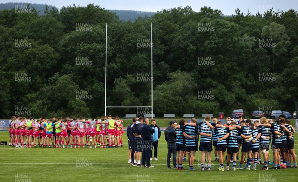 280621 - Cardiff Blues U18 v Dragons U18 - The respective team form their huddles at the end of the match