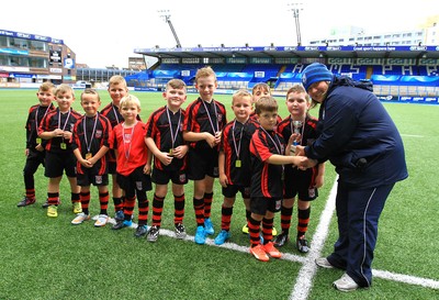 230815 - Cardiff Blues Under 8s Tag Festival - Abercynon receive the trophy from Blues development officer Nadine Griffiths