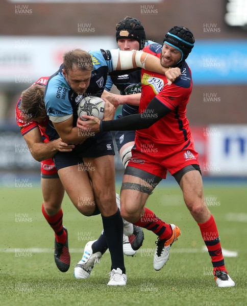 200816 - Cardiff Blues v Bristol Rugby - Pre Season Friendly - Cory Allen of Cardiff Blues is tackled by Adrian Jarvis and Ryan Edwards of Bristol Rugby