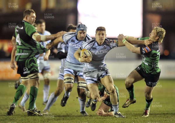 220213 - Cardiff Blues v Connacht - RaboDirect PRO12 - Gavin Evans of Cardiff Blues, centre, holds off the tackle from Connacht's  Kieran Marmion 