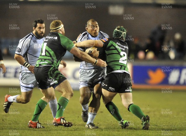 220213 - Cardiff Blues v Connacht - RaboDirect PRO12 - Taufa'ao Filise of Cardiff Blues, centre, holds off the tackle from Connacht's Brett Wilkinson (1) and Jason Harris-Wright (2)