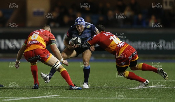 061017 - Cardiff Blues v Dragons Rugby - Guinness PRO14 - Tom James of Cardiff Blues is tackled by James Thomas and Gavin Henson of Dragons