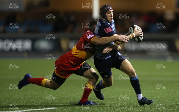 061017 - Cardiff Blues v Dragons Rugby - Guinness PRO14 - Rhun Williams of Cardiff Blues is tackled by Adam Warren of Dragons
