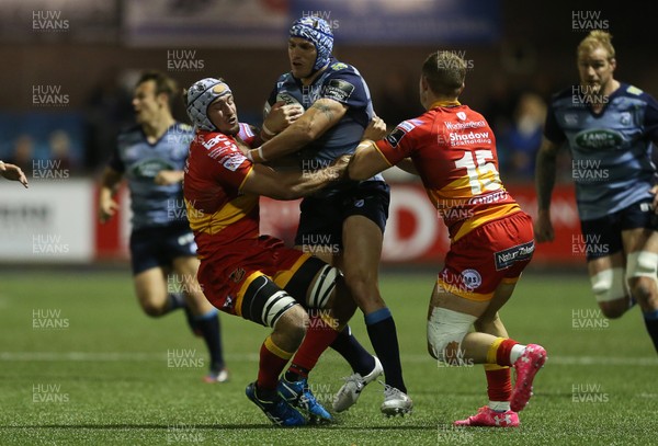 061017 - Cardiff Blues v Dragons Rugby - Guinness PRO14 - Tom James of Cardiff Blues is tackled by Ollie Griffiths and Hallam Amos of Dragons