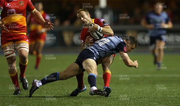 061017 - Cardiff Blues v Dragons Rugby - Guinness PRO14 - Sarel Pretorius of Dragons is tackled by Tomos Williams of Cardiff Blues