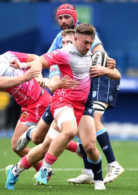 090521 - Cardiff Blues v Dragons - Guinness PRO14 Rainbow Cup - Taine Basham of Dragons is tackled by Max Llewellyn and Owen Lane of Cardiff Blues