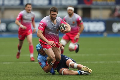 090521 - Cardiff Blues v Dragons, Guinness PRO14 Rainbow Cup - Jonah Holmes of Dragons looks for support as he is tackled by Olly Robinson of Cardiff Blues