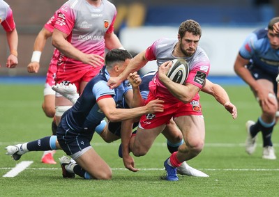 090521 - Cardiff Blues v Dragons, Guinness PRO14 Rainbow Cup - Jonah Holmes of Dragons is held by Ellis Bevan of Cardiff Blues