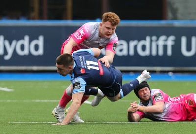 090521 - Cardiff Blues v Dragons, Guinness PRO14 Rainbow Cup - Josh Adams of Cardiff Blues is tackled by Aneurin Owen of Dragons and Ioan Davies of Dragons