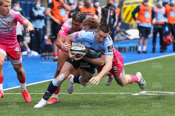 090521 - Cardiff Blues v Dragons, Guinness PRO14 Rainbow Cup - Josh Adams of Cardiff Blues is tackled by Aneurin Owen of Dragons and Rio Dyer of Dragons