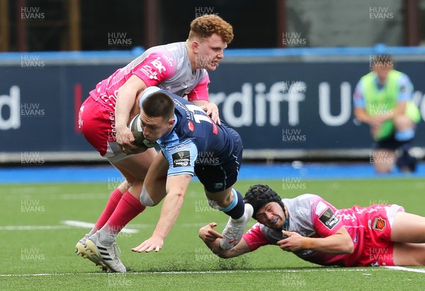 090521 - Cardiff Blues v Dragons, Guinness PRO14 Rainbow Cup - Josh Adams of Cardiff Blues is tackled by Aneurin Owen of Dragons and Ioan Davies of Dragons