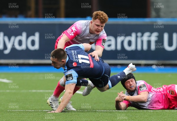 090521 - Cardiff Blues v Dragons, Guinness PRO14 Rainbow Cup - Josh Adams of Cardiff Blues is tackled by Aneurin Owen of Dragons and Ioan Davies of Dragons