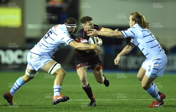 211218 - Cardiff Blues v Dragons Rugby - Guinness PRO14 - Josh Lewis of Dragons is tackled by Josh Turnbull and Kristian Dacey of Cardiff Blues
