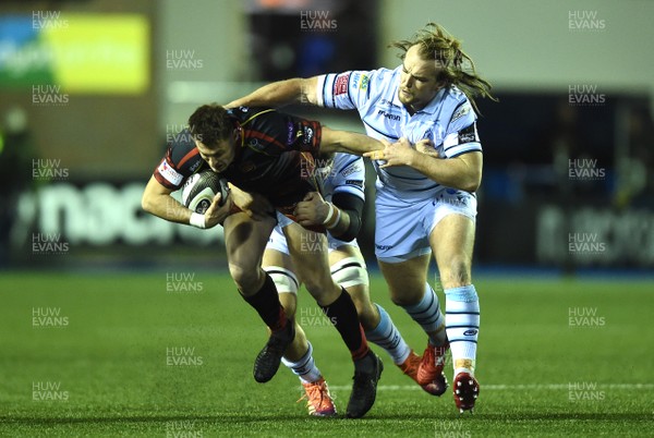 211218 - Cardiff Blues v Dragons Rugby - Guinness PRO14 - Josh Lewis of Dragons is tackled by Josh Turnbull and Kristian Dacey of Cardiff Blues
