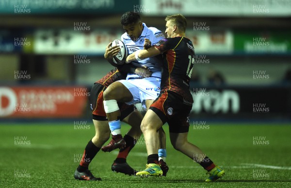 211218 - Cardiff Blues v Dragons Rugby - Guinness PRO14 - Rey Lee-Lo of Cardiff Blues is tackled by Adam Warren and Jarryd Sage of Dragons