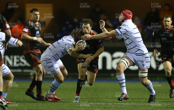 211218 - Cardiff Blues v Dragons - Guinness PRO14 - Zane Kirchner of Dragons is tackled by Kristian Dacey and Seb Davies of Cardiff Blues