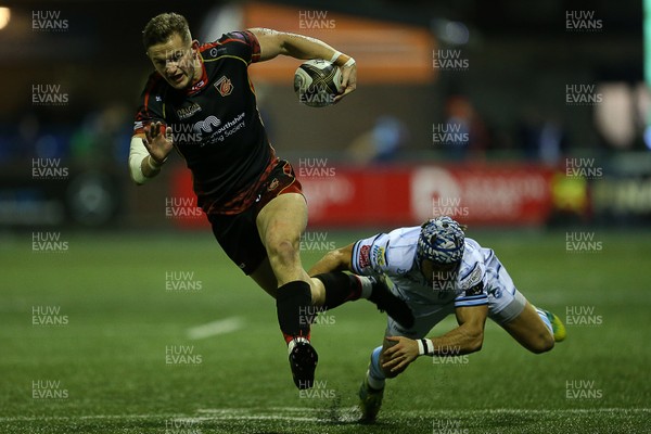 211218 - Cardiff Blues v Dragons - Guinness PRO14 - Hallam Amos of Dragons is tackled by Matthew Morgan of Cardiff Blues