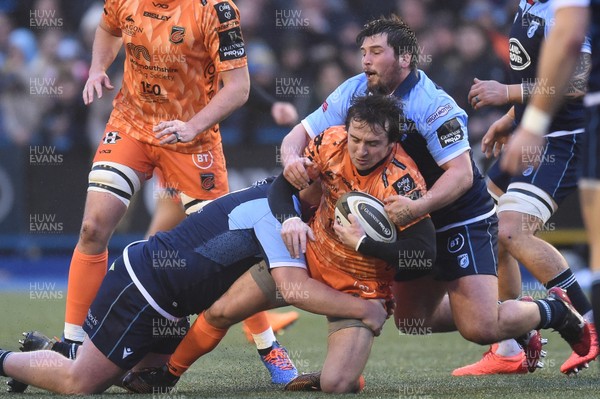 261219 - Cardiff Blues v Dragons - Guinness PRO14 - Rhodri Williams of Dragons is tackled by Keiron Assiratti of Cardiff Blues and Brad Thyer of Cardiff Blues 
