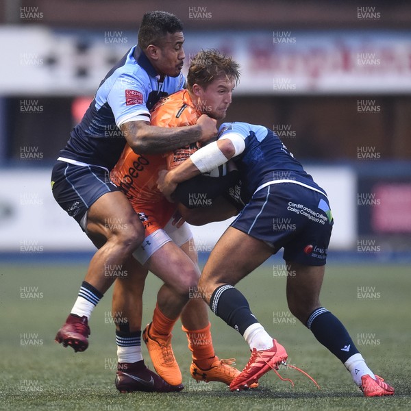 261219 - Cardiff Blues v Dragons - Guinness PRO14 - Tyler Morgan of Dragons is tackled by Rey Lee-Lo of Cardiff Blues  and Ben Thomas of Cardiff Blues 