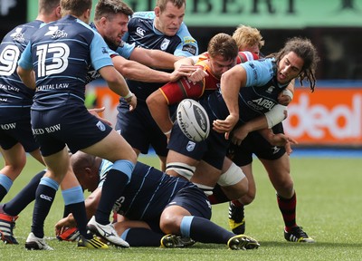 290815 - Cardiff Blues v Newport Gwent Dragons, Pre-Season Friendly -Josh Navidi of Cardiff Blues makes the ball available as he's tackled by Lewis Evans of Newport Gwent Dragons