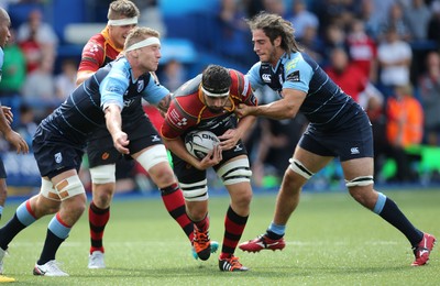 290815 - Cardiff Blues v Newport Gwent Dragons, Pre-Season Friendly -Cory Hill of Newport Gwent Dragons is tackled by Jarras Hoeata of Cardiff Blues and Josh Navidi of Cardiff Blues