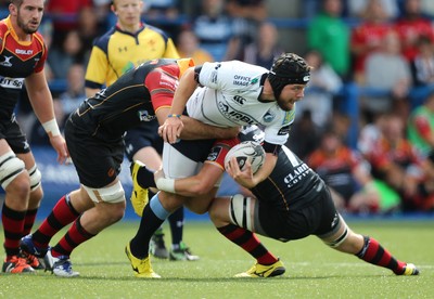 290815 - Cardiff Blues v Newport Gwent Dragons, Pre-Season Friendly -Adam Thomas of Cardiff Blues is tackled by Nick Crosswell of Newport Gwent Dragons and James Benjamin of Newport Gwent Dragons