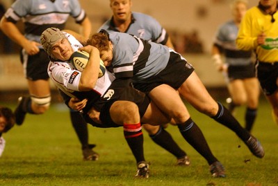 280105 - Cardiff Blues v Edinburgh - Celtic League - Edinburgh's Dougie Hall is brought down by Nathan Thomas