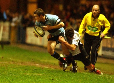 280105 - Cardiff Blues v Edinburgh - Celtic League - Blues' Jonny Vaughton looks for support as Michael Pyke tackles