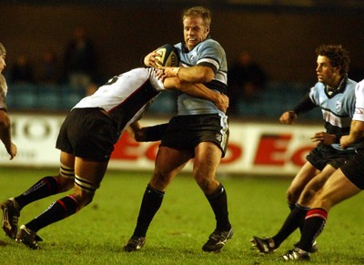 280105 - Cardiff Blues v Edinburgh - Celtic League - Blues' Jon Bryant is tackled by David Callum