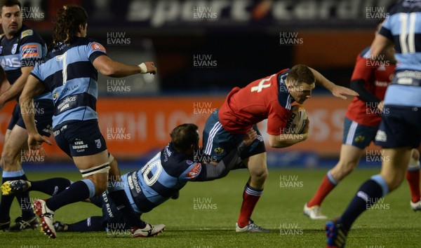 231113 - Cardiff Blues v Munster - RaboDirect PRO12 -Andrew Conway of Munster is tackled by Simon Humberstone of Cardiff Blues