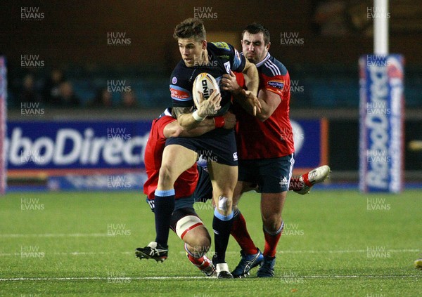 231113 Cardiff Blues v Munster - RaboDirectPro12 -Gavin Evans of The Blues is tackled by CJ Stander(L) and James Cronin of Munster