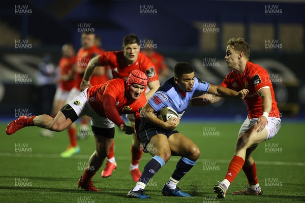 260221 - Cardiff Blues v Munster - Guinness PRO14 - Ben Thomas of Cardiff Blues is tackled by Chris Cloete and Calvin Nash of Munster
