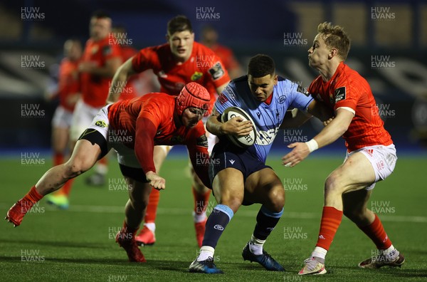 260221 - Cardiff Blues v Munster - Guinness PRO14 - Ben Thomas of Cardiff Blues is tackled by Chris Cloete and Calvin Nash of Munster