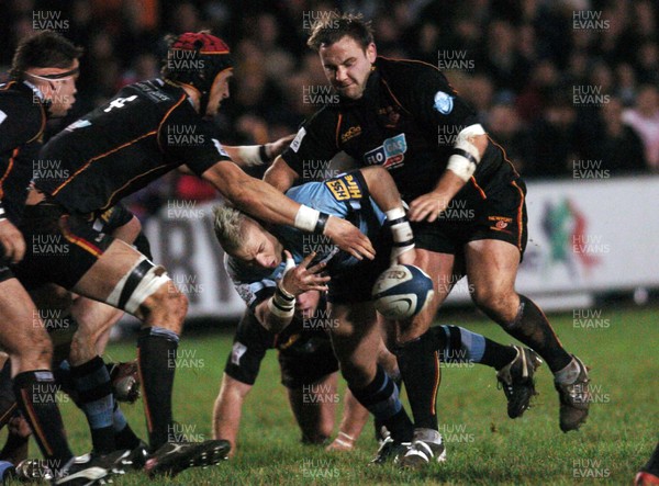 271205 - Cardiff Blues v Newport Gwent Dragons - Celtic League -  Cardiff's Ryan Powell spills the ball as Luke Charteris and David Maddocks challenge