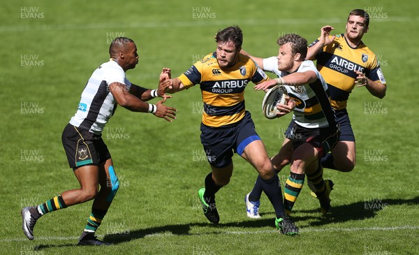 070816 - Singha Premiership Rugby 7s Series Final - Plate Semi Final - Cardiff Blues v  Northampton Saints - Adam Thomas of Cardiff Blues is tackled by Yiannis Lozias and Charlie Kingham of Northampton