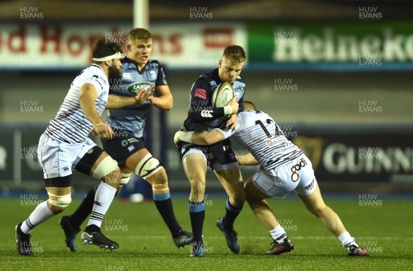 171117 - Cardiff Blues v Ospreys - Anglo Welsh Cup - Gareth Anscombe of Cardiff Blues is tackled by Kieran Williams of Ospreys