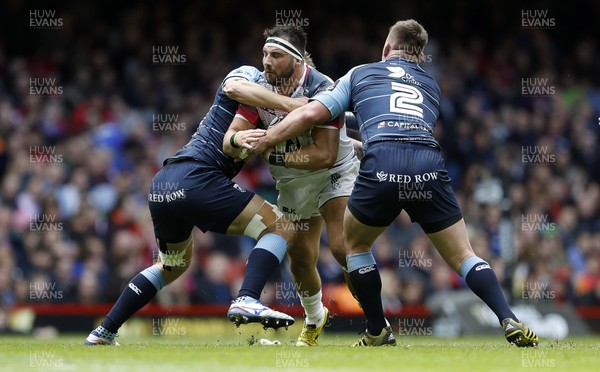 300416 - Cardiff Blues v Ospreys - Judgement Day - Guinness PRO12 - Scott Baldwin of Ospreys is tackled by Jarrad Hoeata and Matthew Rees of Cardiff Blues