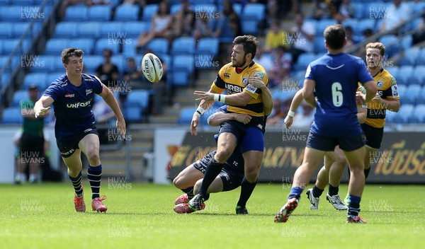 070816 - Singha Premiership Rugby 7s Series Final - Quarter Final - Cardiff Blues v Sale Sharks - Adam Thomas of Cardiff Blues is tackled by Tom Curry of Sale