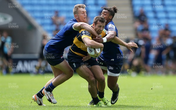 070816 - Singha Premiership Rugby 7s Series Final - Quarter Final - Cardiff Blues v Sale Sharks - James Beale of Cardiff Blues is tackled by Nick Scott and Paolo Odogwu of Sale