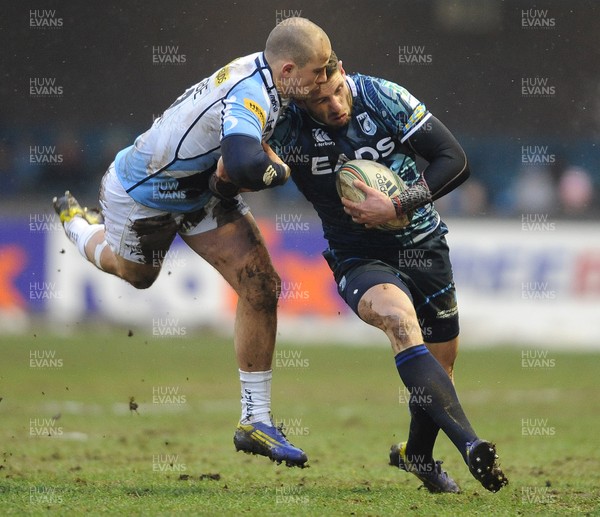 190113 - Cardiff Blues v Sale Sharks - Heineken Cup -Alex Cuthbert of Cardiff Blues is tackled by Mark Jennings of Sale