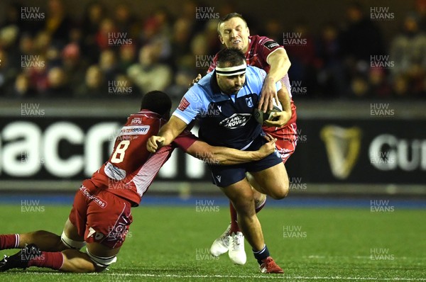 030120 - Cardiff Blues v Scarlets - Guinness PRO14 - Liam Belcher of Cardiff Blues is tackled by Uzair Cassiem and Hadleigh Parkes of Scarlets
