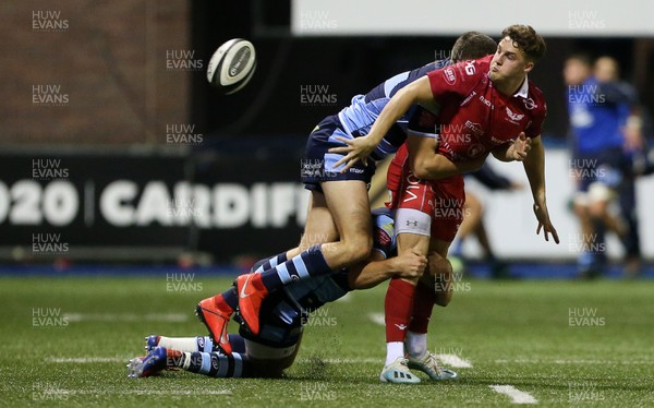 041019 - Cardiff Blues A v Scarlets A - Celtic Cup - Tomi Lewis of Scarlets is tackled by Mason Grady and Sam Jones of Cardiff Blues