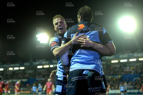 220319 - Cardiff Blues v Scarlets - Guinness PRO14 - Gareth Anscombe and Josh Turnbull celebrate with Owen Lane of Cardiff Blues after scoring try