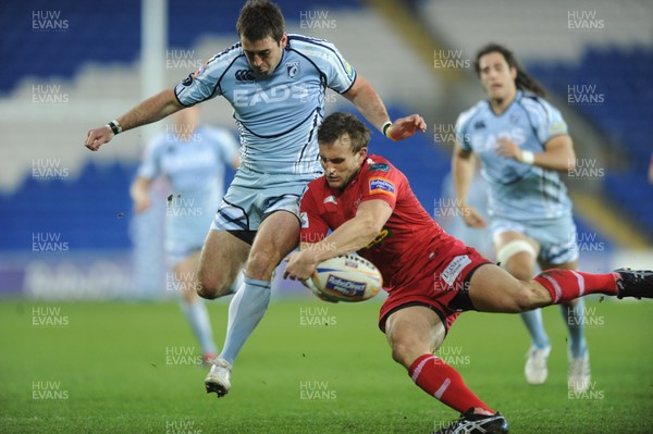 240312 - Cardiff Blues v Scarlets - RaboDirect PRO12 -Dafydd Hewitt of Cardiff Blues and Andy Fenby of Scarlets compete for the ball