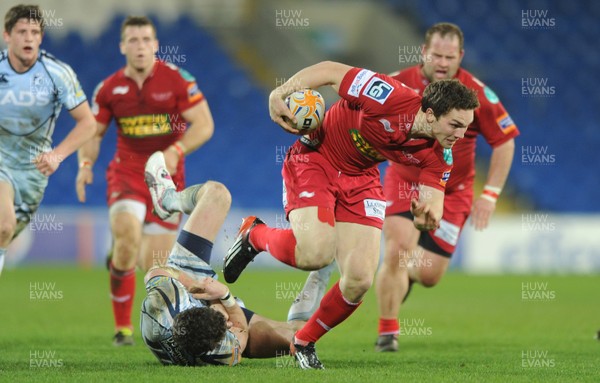 240312 - Cardiff Blues v Scarlets - RaboDirect PRO12 -George North of Scarlets beats Alex Cuthbert (ground) of Cardiff Blues